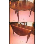DROP-LEAF TABLE, George III mahogany with hinged oval top and later castors,