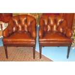 TUB ARMCHAIRS, a pair, deep buttoned tan brown leather with rounded backs and turned front supports,