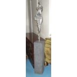 SCULPTURE, polished metal of a maiden on grey composite stone plinth, 167cm H x 20cm.