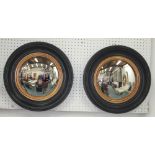 WALL MIRRORS, a set of six, Regency style circular black and gold each with convex plate, 40cm diam.
