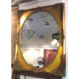 WALL MIRROR, 19th century style with oval plate within a rectangular decorative gilt frame,