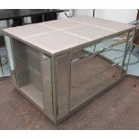 CENTRE DRESSING ROOM CHEST, upholstered top on a base with mirrored drawers and glass shelves,