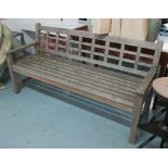 GARDEN BENCH, weathered teak slatted on square supports, 183cm L.