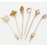 A collection of gem set tie pins to include three pearl set examples; a sapphire and pearl set tie