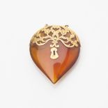 A Victorian gold mounted amber pendant modelled as a padlock, engraved detail with pierced scrolling