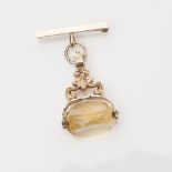 A 9ct gold swivel fob of conventional form with scrolling detail and brooch fittings, the citrine