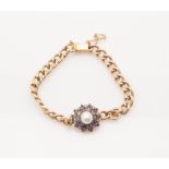 A Edwardian gold curb link bracelet with an onset 19th century rosette, composed of a bouton pearl