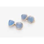 A pair of cabochon chalcedony cufflinks each terminal composed of a blue chalcedony cabochon, collet