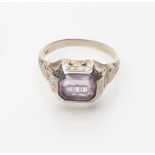 A gentleman's gem set signet ring set with an engraved rectangular cut amethyst, set in yellow metal