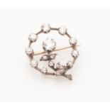 An Edwardian diamond set brooch of open circular form, set throughout with graduated circular mine