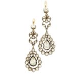 A pair of Edwardian diamond cluster earrings each of open scrolling form, claw set in white metal