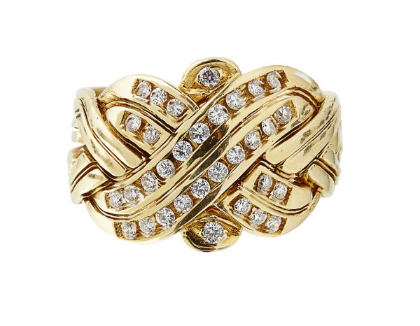 A Russian style diamond set gold 'puzzle' ringapparently unmarked, composed of four pairs of gold