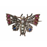 A multi-gem set butterfly broochmodelled in unmarked yellow and white metal, the body set with