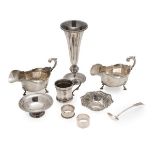 A collection of modern silverto include; a pair of sauce boats, cast moulded rim, leaf clasped
