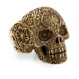 A gentleman's large skull ringmodelled in unmarked yellow metal, with scrolling and foliate detail