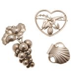 GEORG JENSEN - A group of three silver broochesthe first modelled as a heart and dolphins, No.