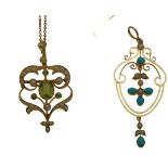 Two Victorian gold, pearl and gem set pendantsthe first of scrolling form, seed pearl set border