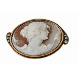 An Art Nouveau cameo broochof oval outline mounted in unmarked yellow metal, depicting a young woman