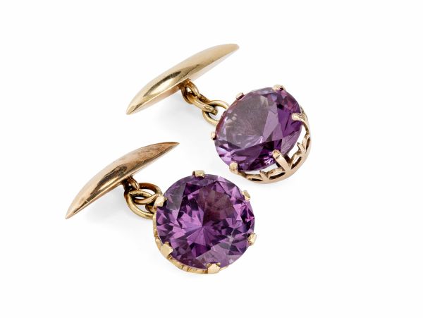 A pair of Alexandrite set cufflinkseach set with a single round cut alexandrite in a unmarked yellow