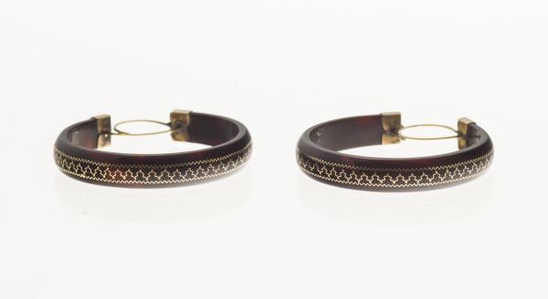 A pair of 19th century tortoiseshell earringsof hoop form, with gold pique work detail, with hook