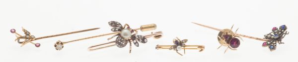 A group of diamond and multi gem set tie pins and broochesto include a gold pin bar brooch with