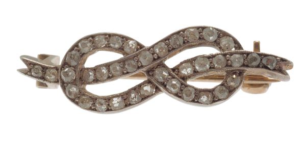 A small all diamond set knot broochset in silver on gold, unmarkedLength: 27mm