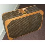 LOUIS VUITTON - A large hard sided suit casethe monogrammed leather with tan leather straps and