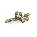 A Russian peridot and diamond set broochmodelled as a floral spray and set throughout with round cut