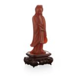 AMBER CARVED STANDING FIGURE OF GUANYINQING DYNASTY, 19TH CENTURYfinely modelled as the Goddess of