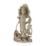 CARVED WOOD FIGURE OF GUANYINthe Goddess of Compassion standing on a writhing dragon emerging from