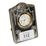 A small Carr's of Sheffield silver cased 1994 bedside clock with foliate and swag designs