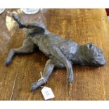 A bronze figurine of a recumbent dog, 32cm long