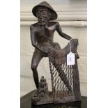 An Oriental hard wood carved figure of a fisherman with his nets, 40cm high