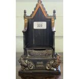 A bronze child's money box by Harper in the form of a throne to commemorate the 1953 Coronation,