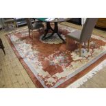 A contemporary Oriental-style wool drawing room rug with multicoloured floral and foliate depictions