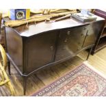 A Georgian-style mahogany sideboard with serpentine shaped front, four central drawers with two