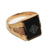 A 9 carat gold signet ring set with black onyx stone with small diamond to centre