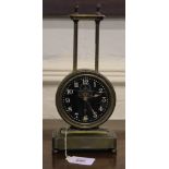 A 19th century circular brass self winding mantle clock on an oblong base