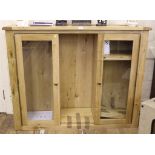 A contemporary hardwood floor display cabinet with shaped top, two glazed doors, central shelved