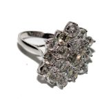 A large diamond cluster ring set with nineteen round diamonds with a total diamond weight of 4.58