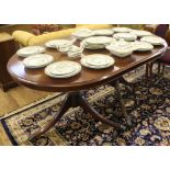 A Regency-style 'D' end mahogany dining table with string inlay to the shaped top, raised on twin