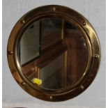 A circular brass framed wall mirror