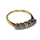 A five stone diamond ring set in 18 carat gold platinum