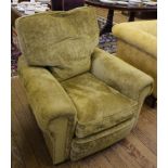 An early 20th century fabric upholstered armchair with removable cushions, raised on castors