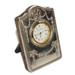 *A small silver bedside clock