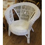 A white painted wicker conservatory chair with hoop back support and circular seat