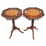 A pair of Georgian-style mahogany wine tables with circular pie crust tops, raised on turned central