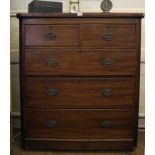 A Victorian mahogany chest of two short and three graduating drawers with shaped top, oval brass