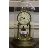 An early 20th century perpetual clock under glass dome and circular brass base