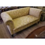 A 19th century-style fabric upholstered Chesterfield three seater sofa with adjustable arm rest,